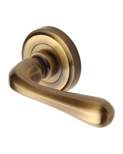 Antique Brass Charlbury Door Handle on Round Rose